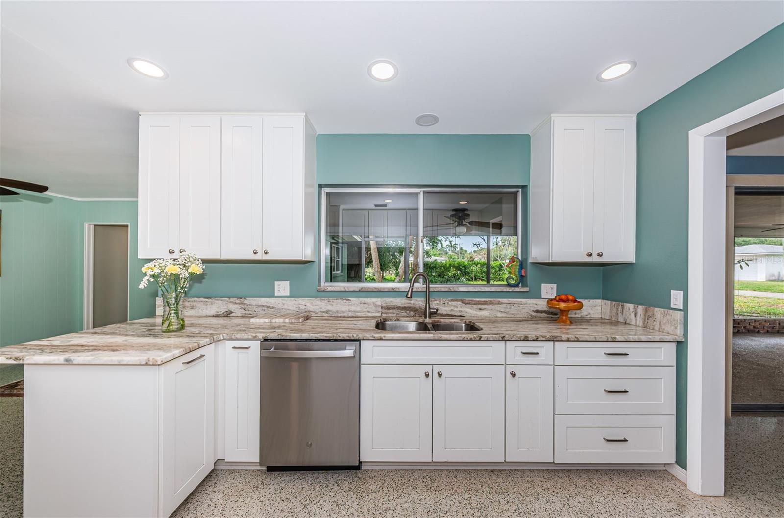 Updated kitchen with solid wood cabinetry, quartz counters, and stainless appliances.