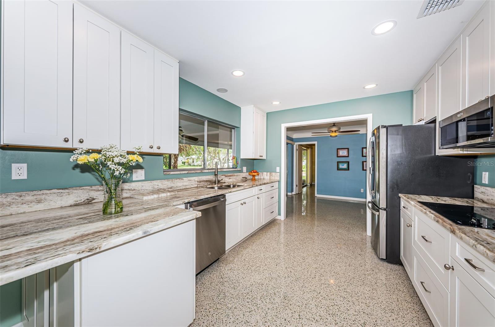 Updated kitchen with solid wood cabinetry, quartz counters, and stainless appliances.