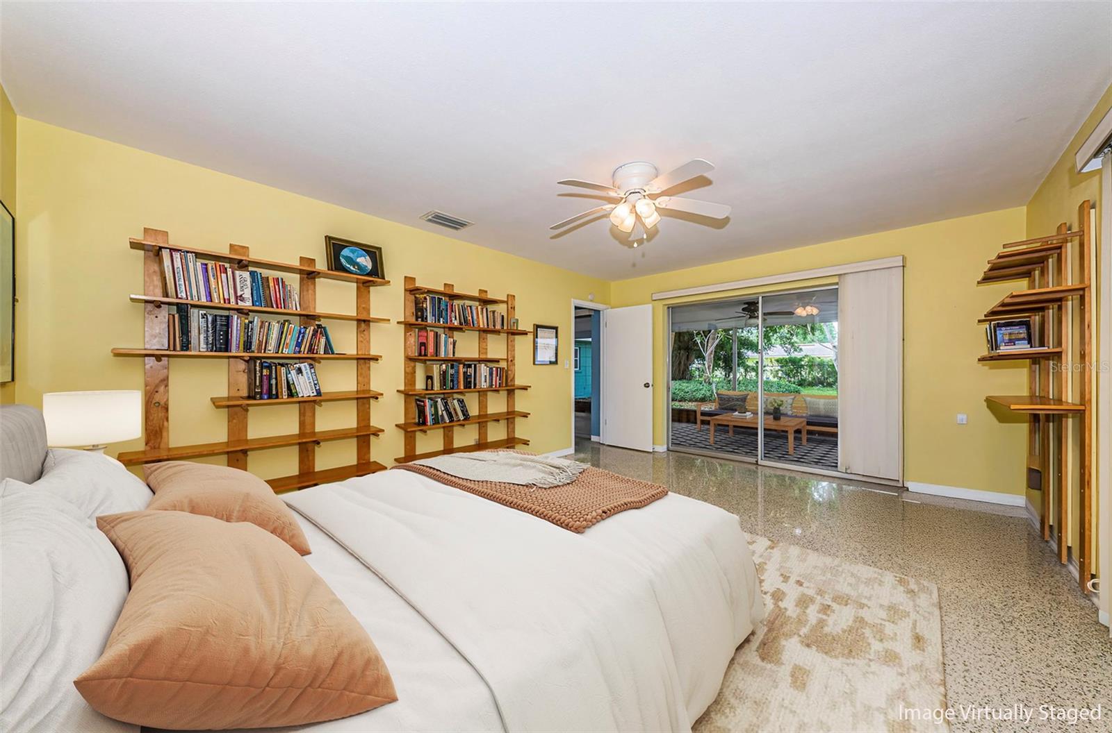 Primary bedroom with en-suite bathroom. It overlooks the large screened porch and backyard.