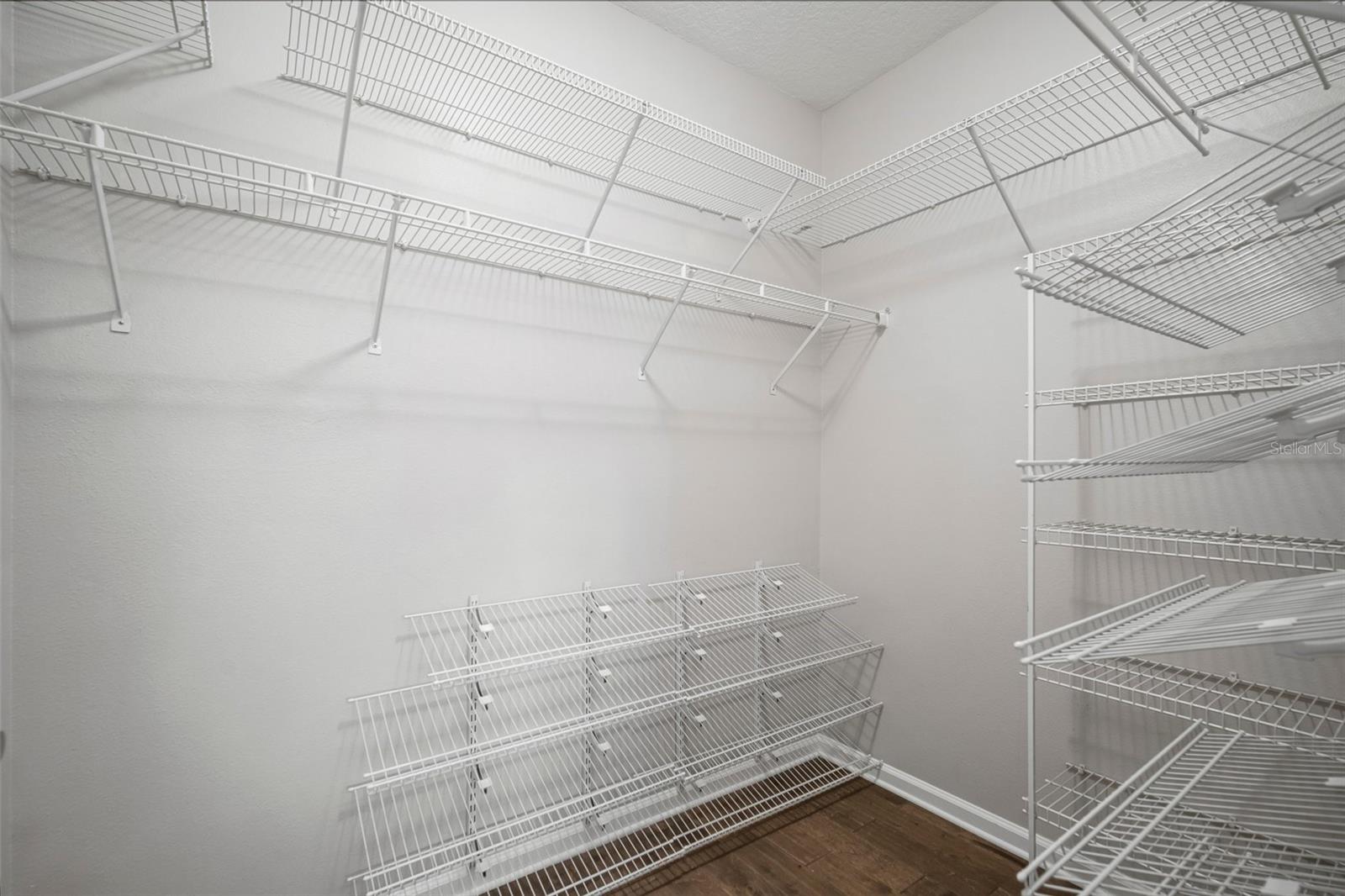 Primary suite walk-in closet & added shelving