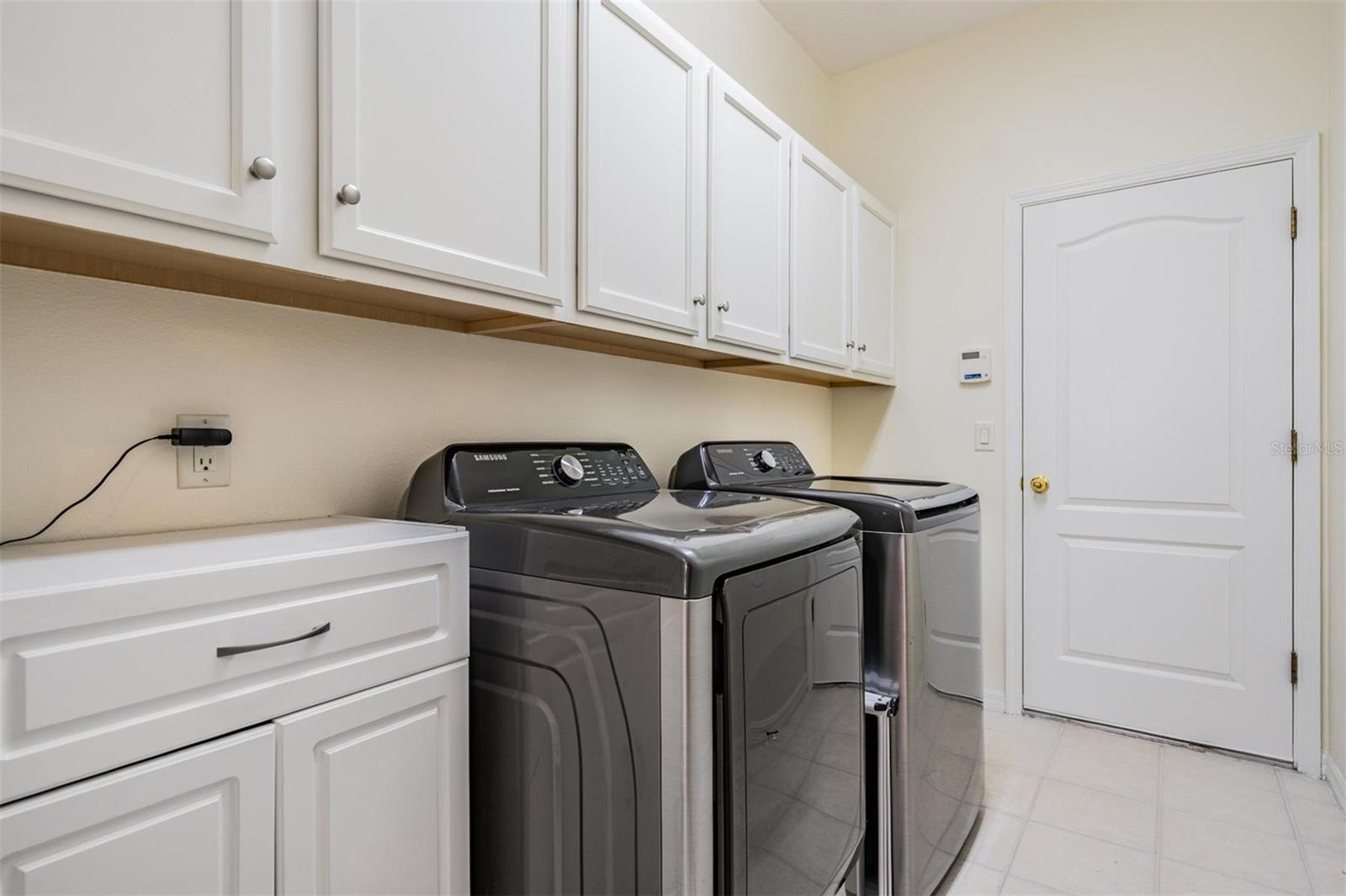 Walk-in laundry room with more than ample additional storage options
