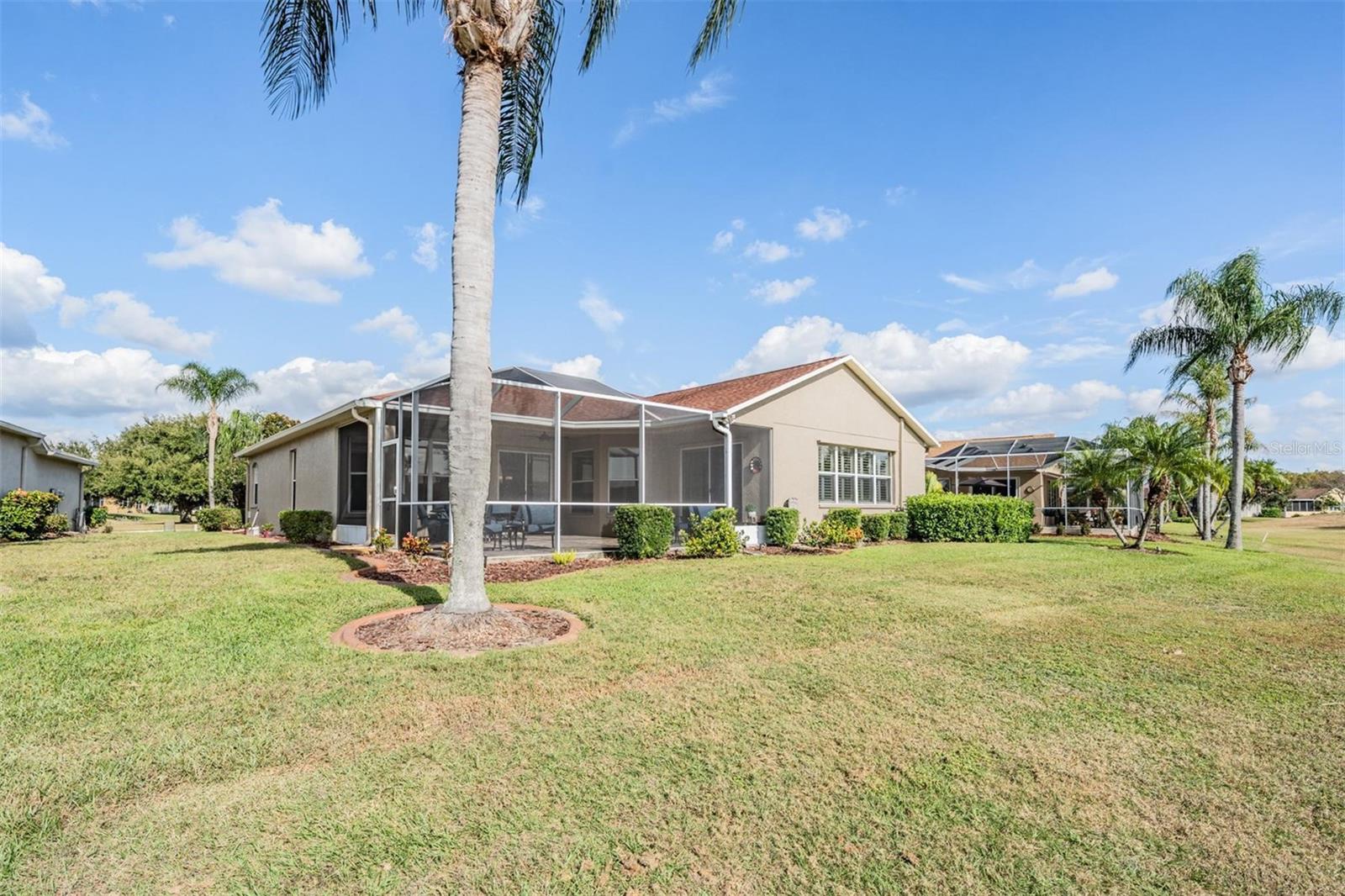 Exterior back shows screened in lanai