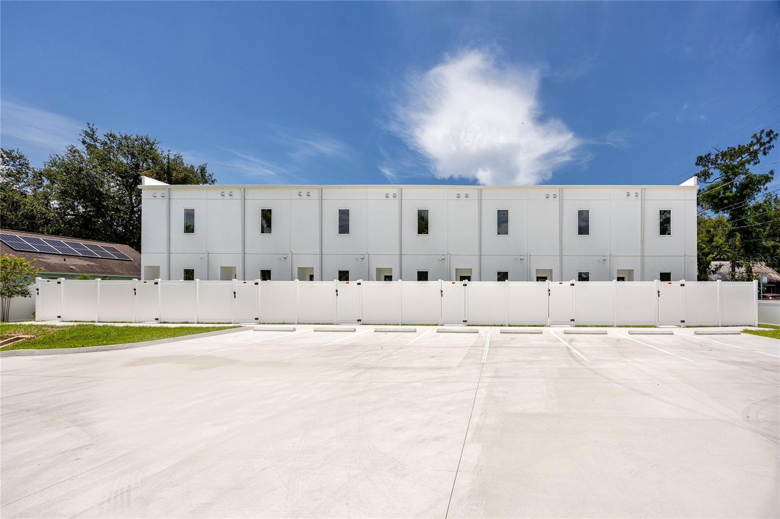 View of parking pad and back view of townhome complex
