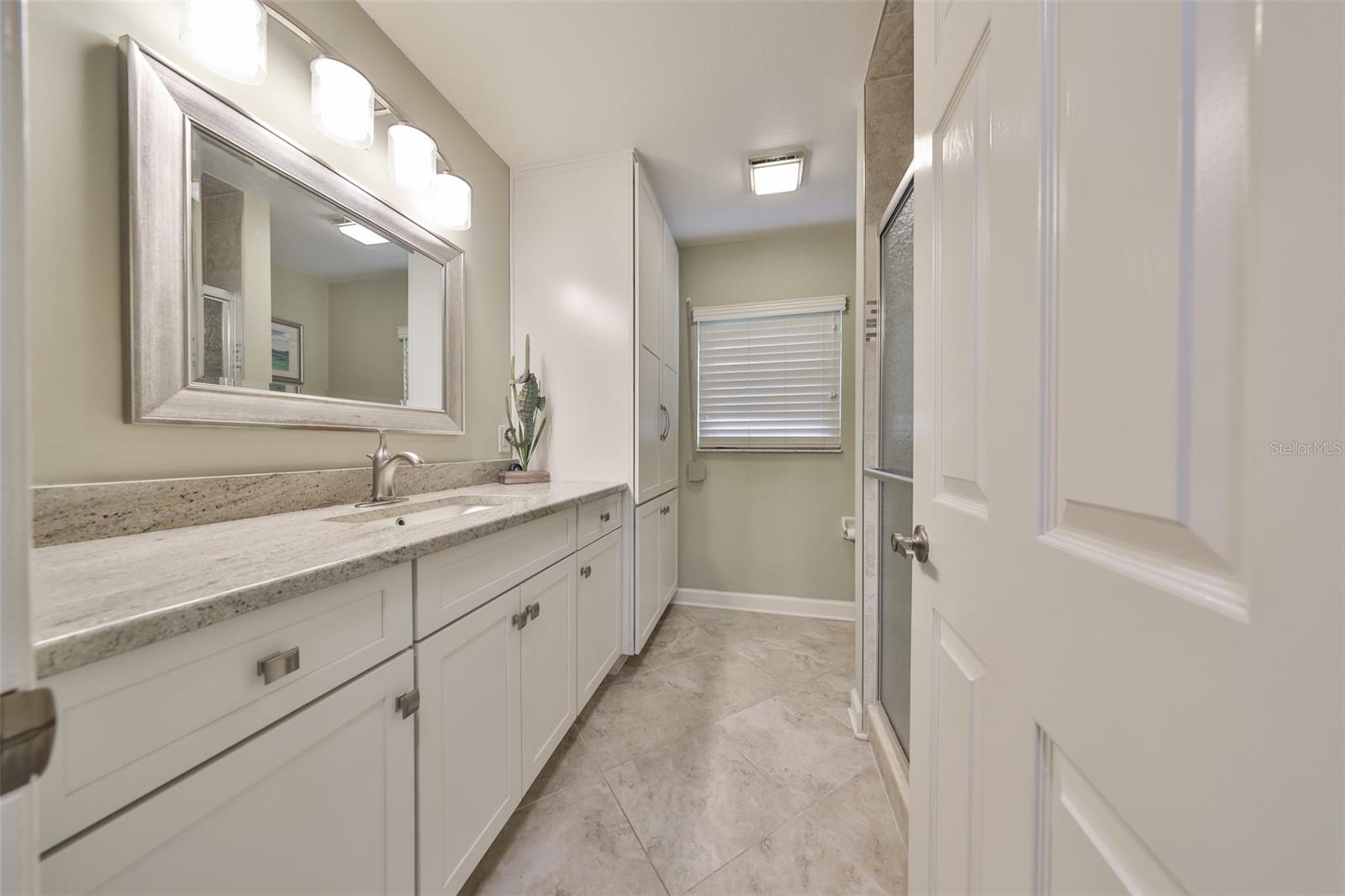 Remodeled Guest Bathroom w/High Vanity, Custom Cabinets, & Floor to Ceiling Tiled Walk-In Shower
