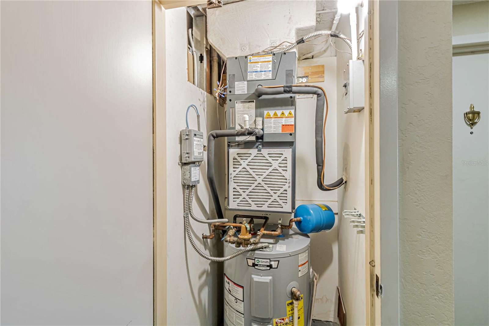 Utilities closet, just outside the unit