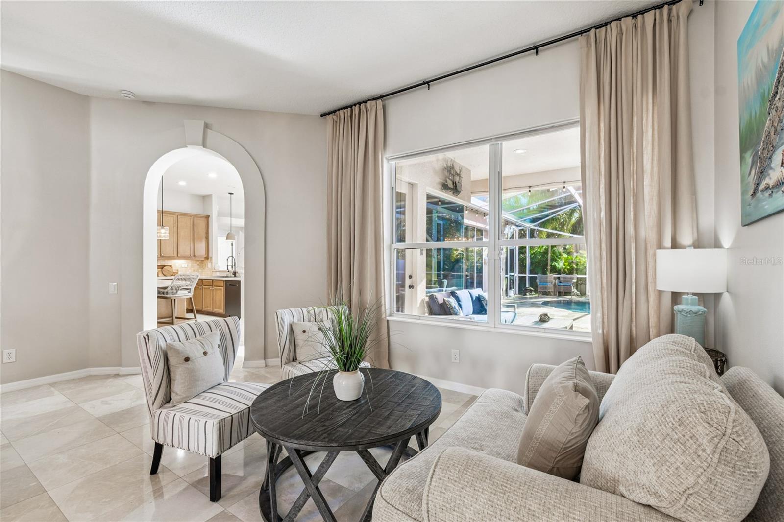 Formal living room with distant view of the kitchen