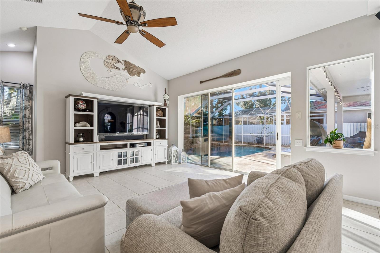 Family room with pool view and triple slider to pool area