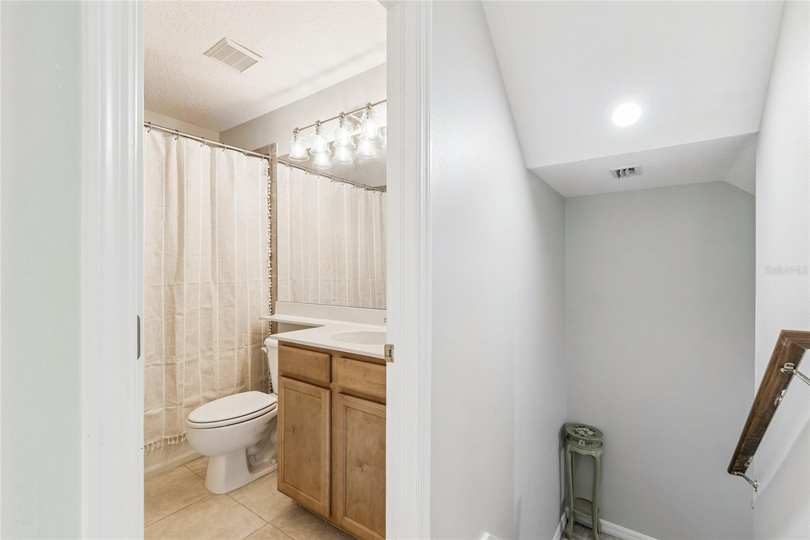 Fourth bathroom on 2nd level and partial view of staircase