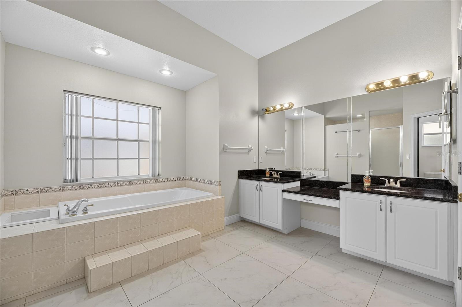 Dual sinks with granite countertops.