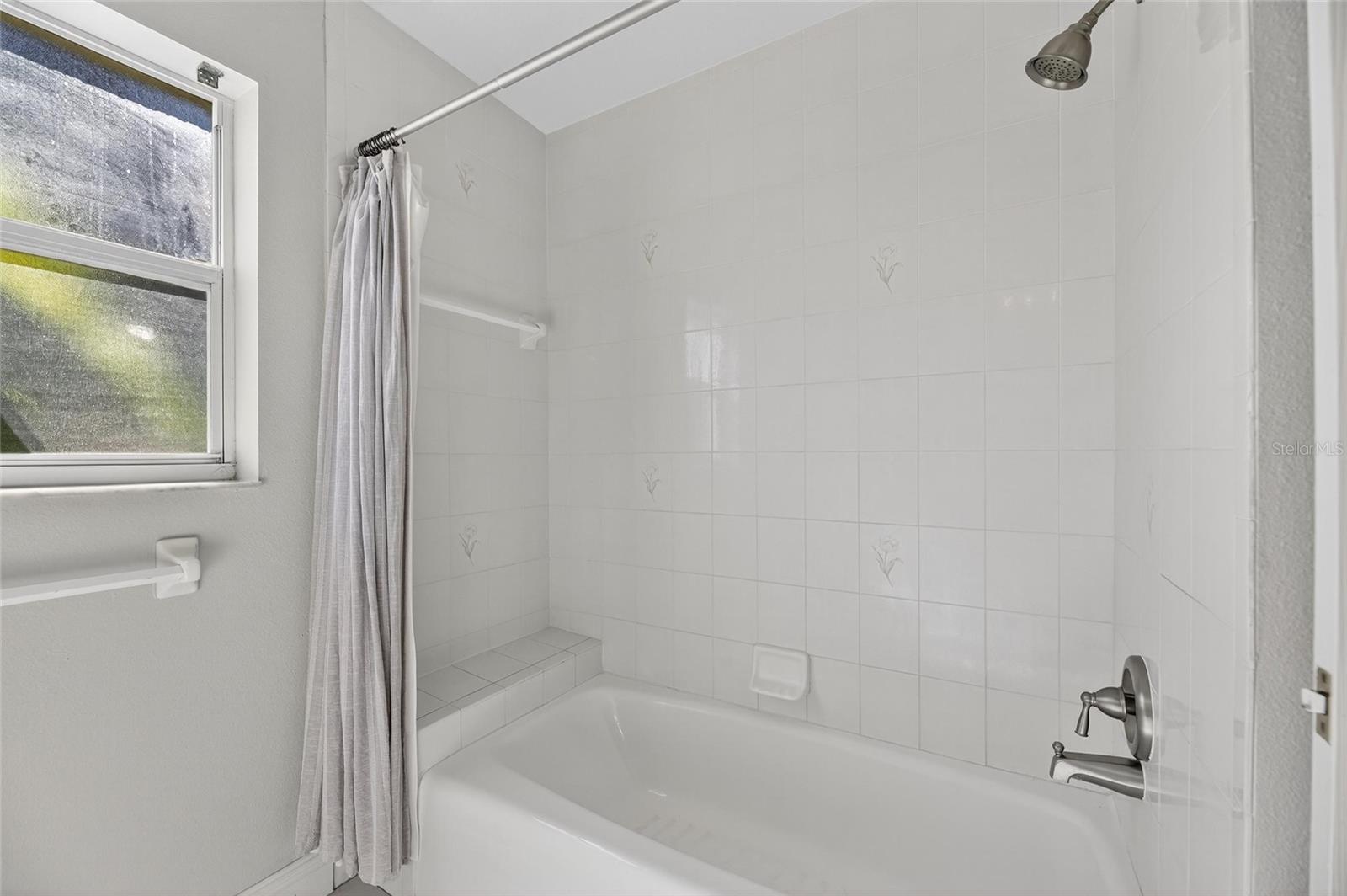 Guest bath with combination shower and tub.