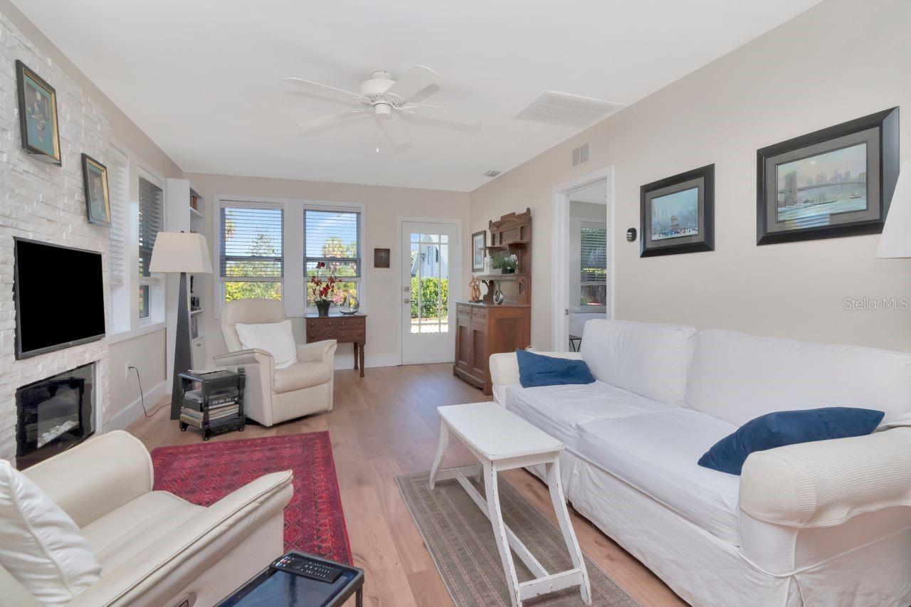 Living room with an electric fire place that warns the room.