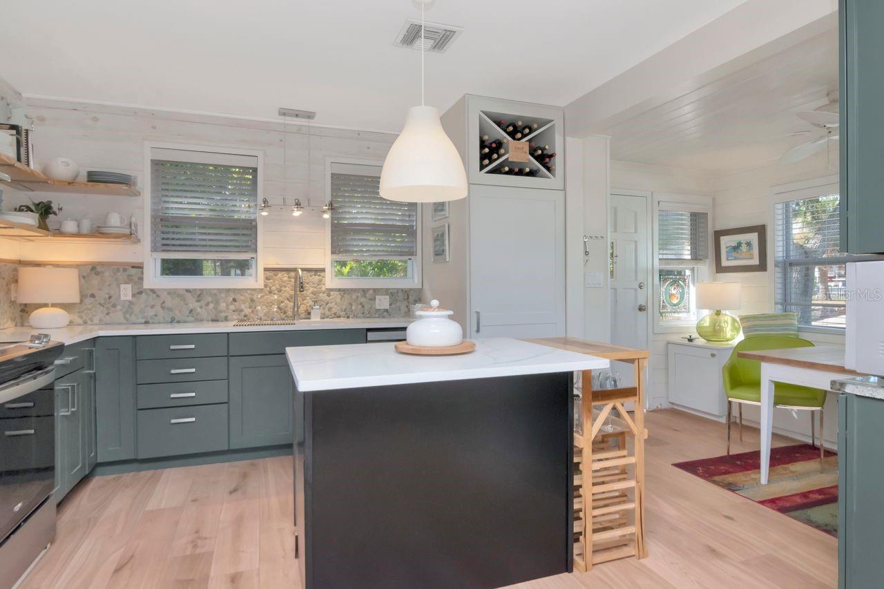 A kitchen with an island and breakfast nook.