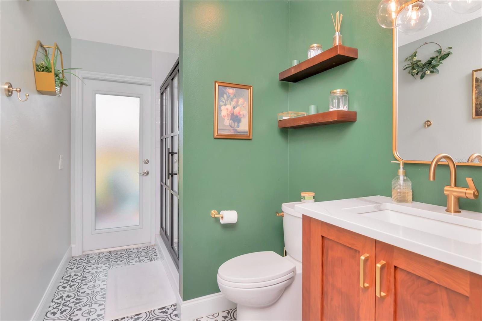Redone bathroom with beautiful floors and shower door