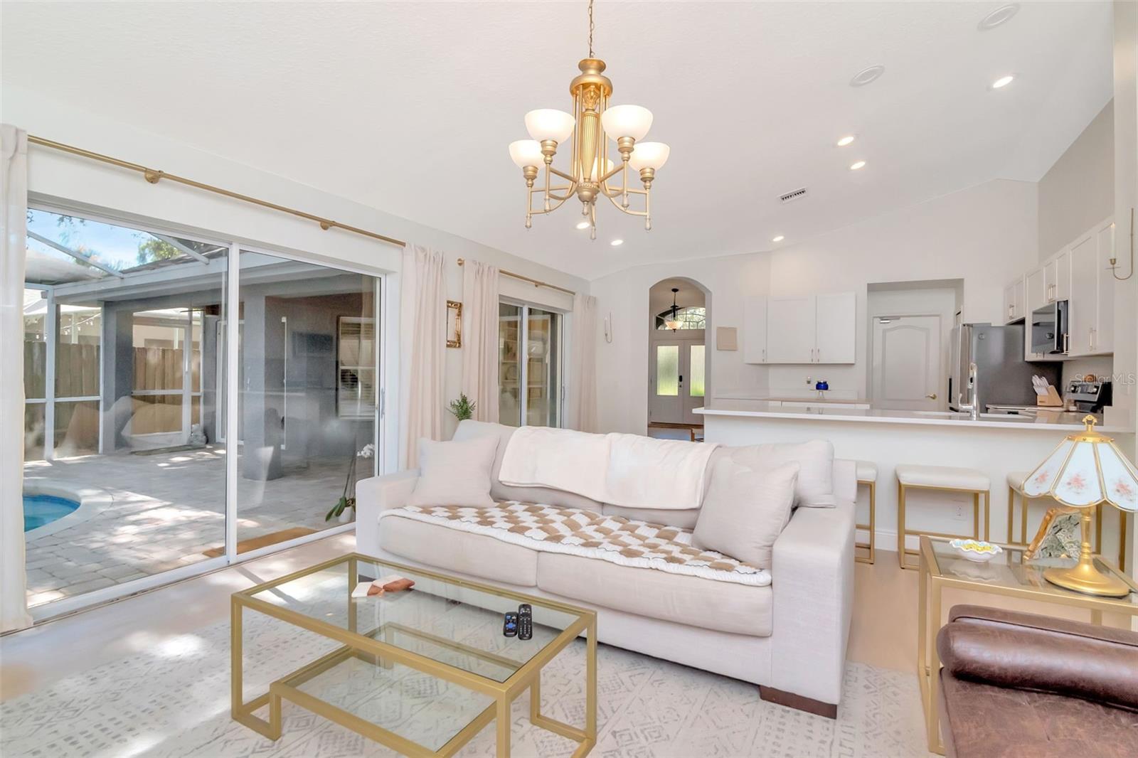 Family room that opens to kitchen and outdoor pool area