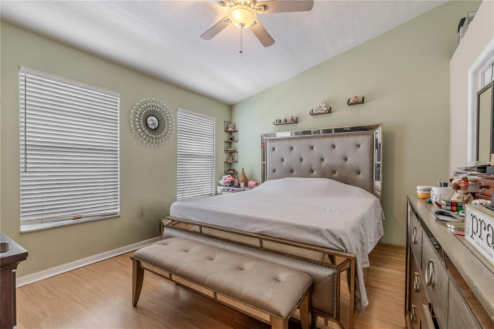 Defined by its vaulted ceiling and clean lines, the master suite embodies modern serenity. A seamless flow connects the sleeping area, en-suite bath, and walk-in closet, where a thoughtfully placed windows brings in natural light for balance and clarity.