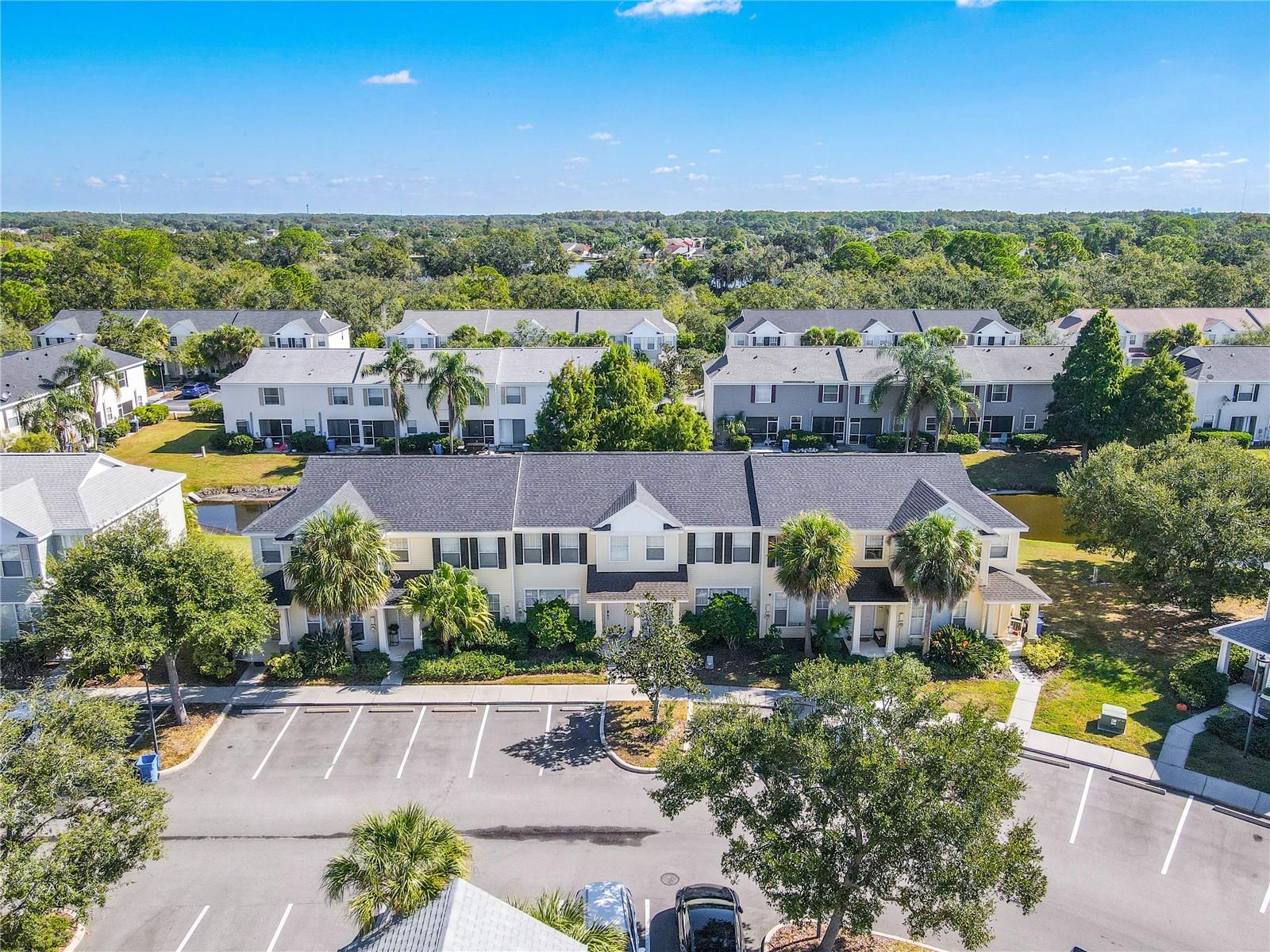 The home welcomes you with a thoughtfully designed entrance, framed by lush greenery that softens the approach. Adjacent, neatly arranged parking spaces offer convenience and ease, making arrival effortless. Together, they create an inviting first impression that blends functionality with charm.