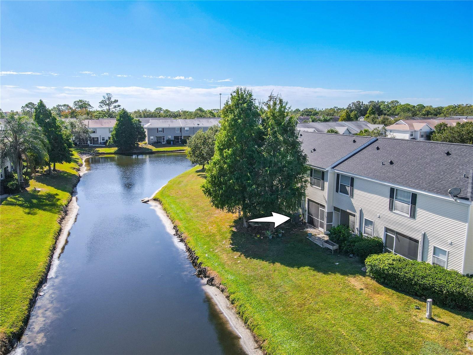 This areal view reveals the unobstructed water views complemented by a several, well-placed shade trees. The combination of open space, natural beauty, and subtle greenery creates a simple, serene outdoor setting for living and leisure.