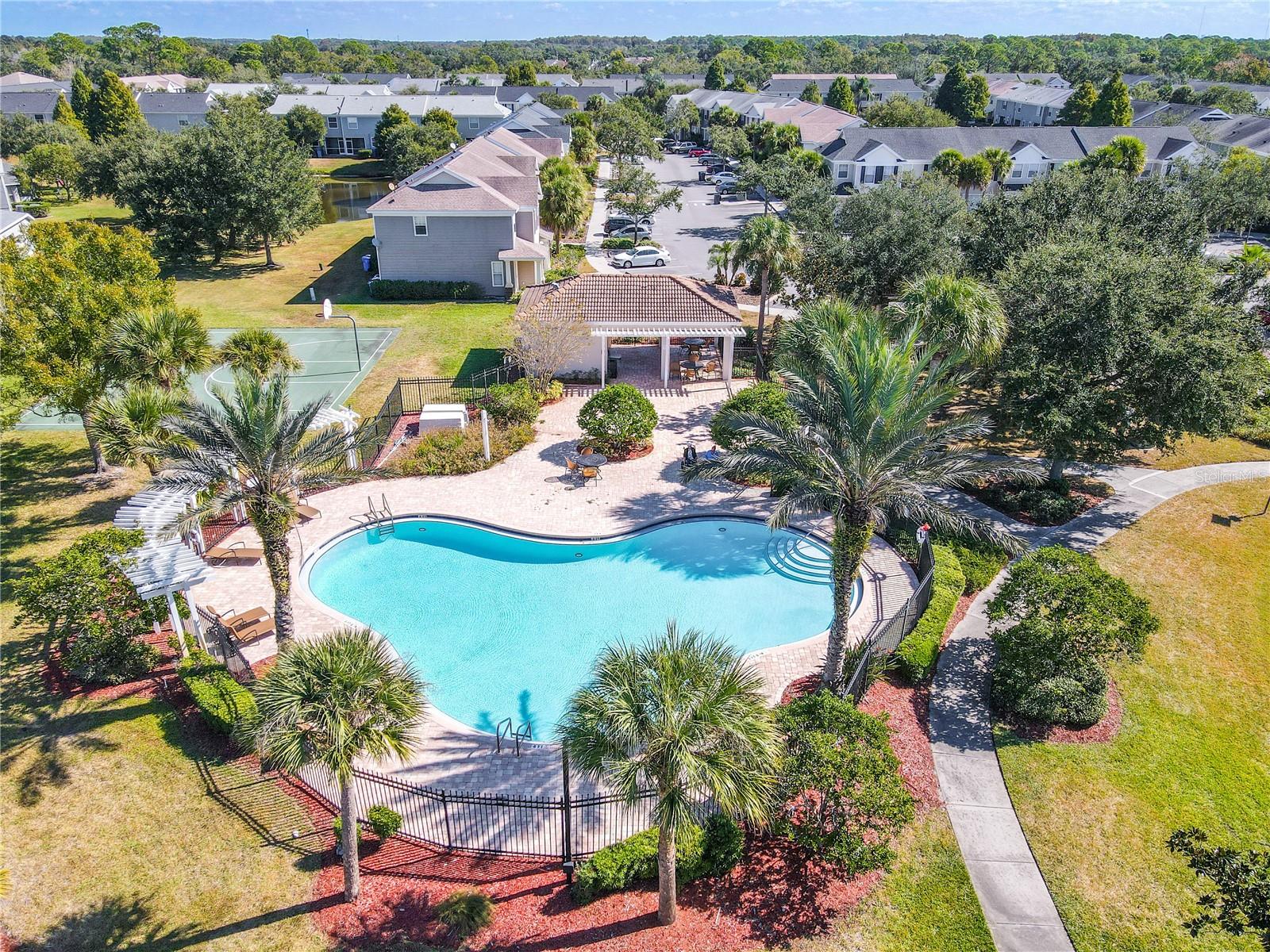 Just look at this view and imagine the relaxation and fun you can have at community pool lined with palm trees and greenery!