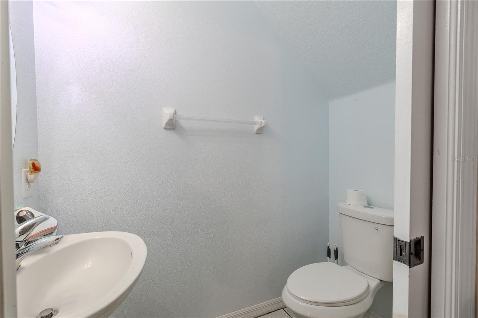 Tucked neatly off the kitchen, the half bath delivers understated sophistication. Clean lines, modern fixtures, and a thoughtful layout make it an unobtrusive yet essential part of the home’s flowing, open design.