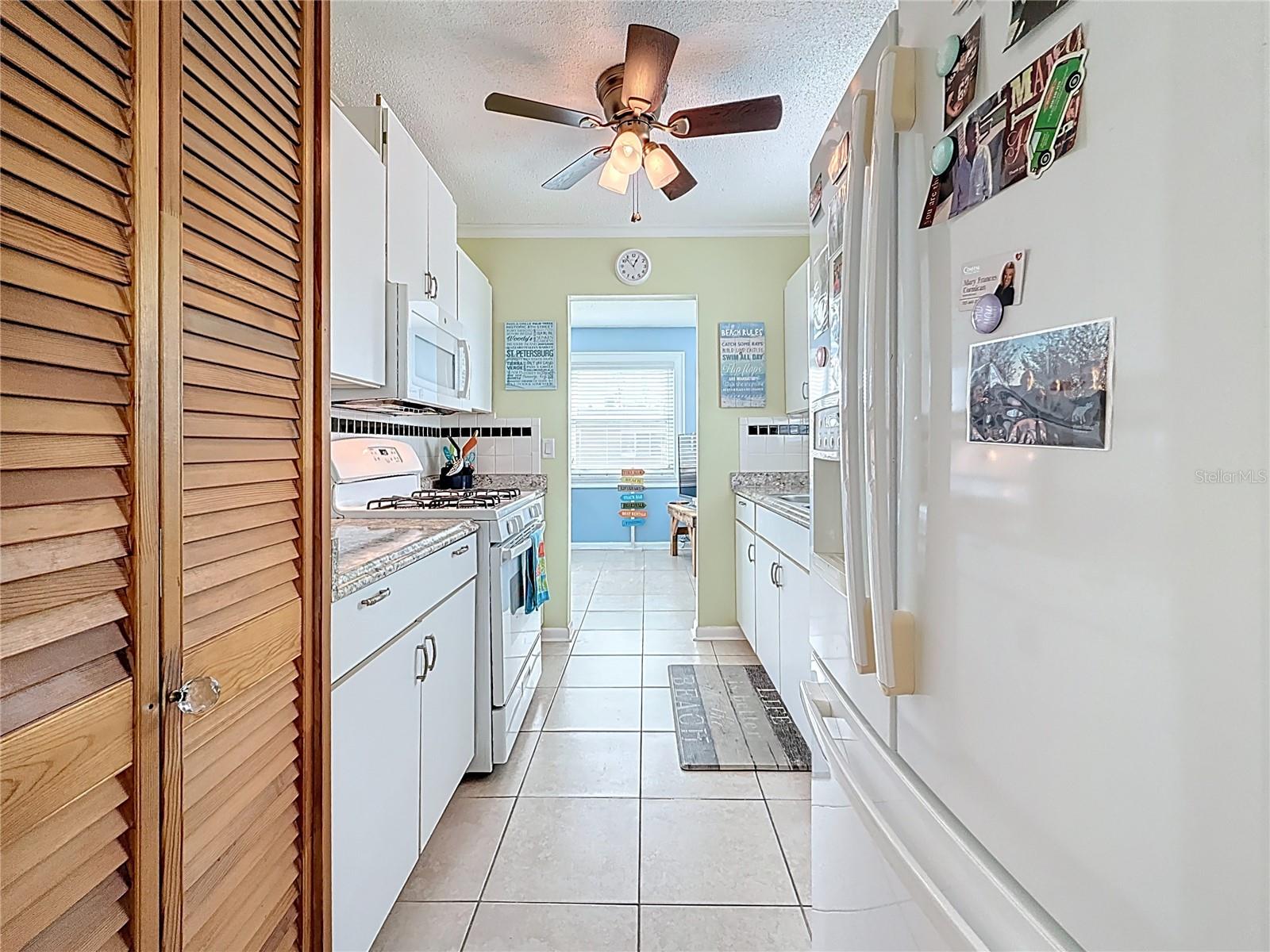 The galley kitchen offers a closet pantry