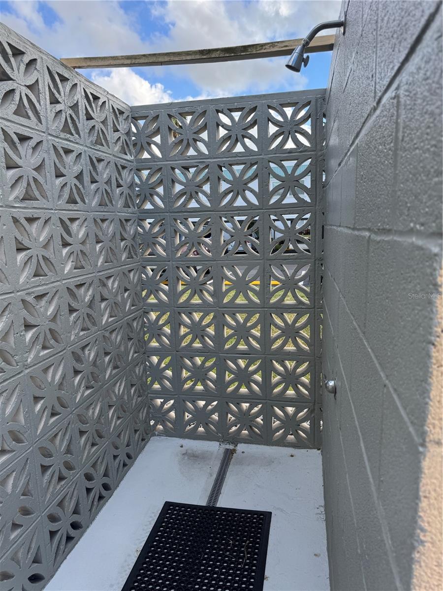 This is an outdoor shower right next to the pool for added convenience