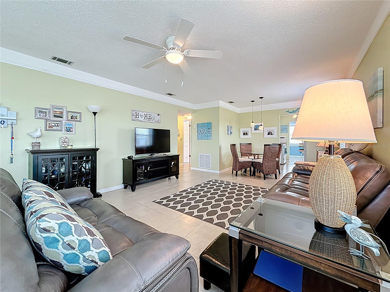 This shows you the living and dining area at a different angle.  This condo is nicely tiled throughout.