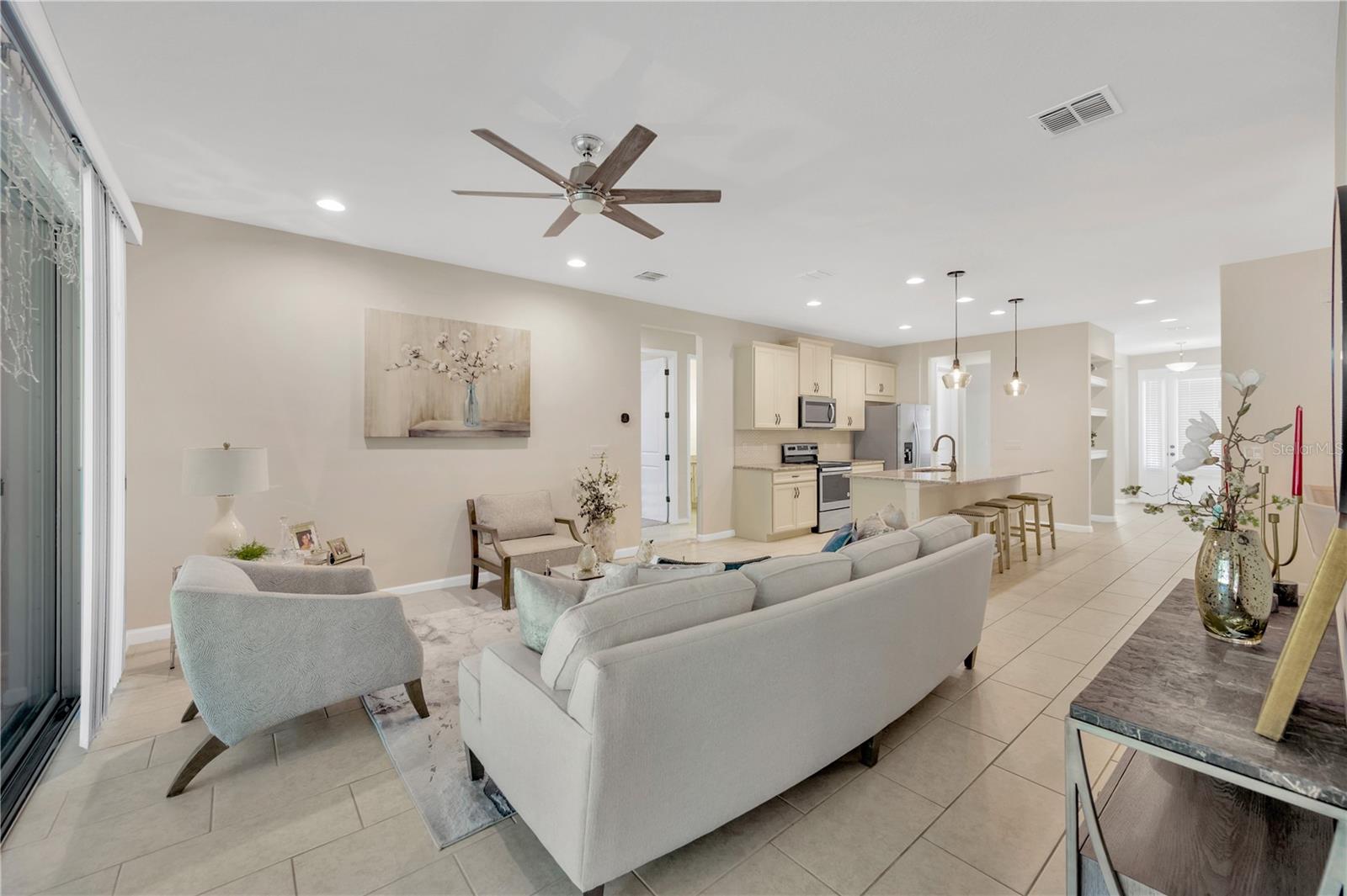 View from the door of primary bedroom 1 into living room and kitchen