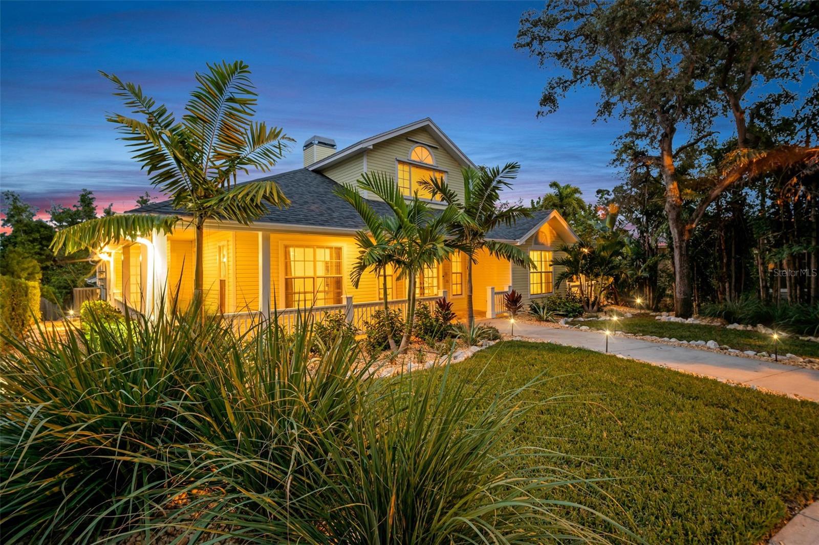 New lush landscaping & uplighting surrounds the home~