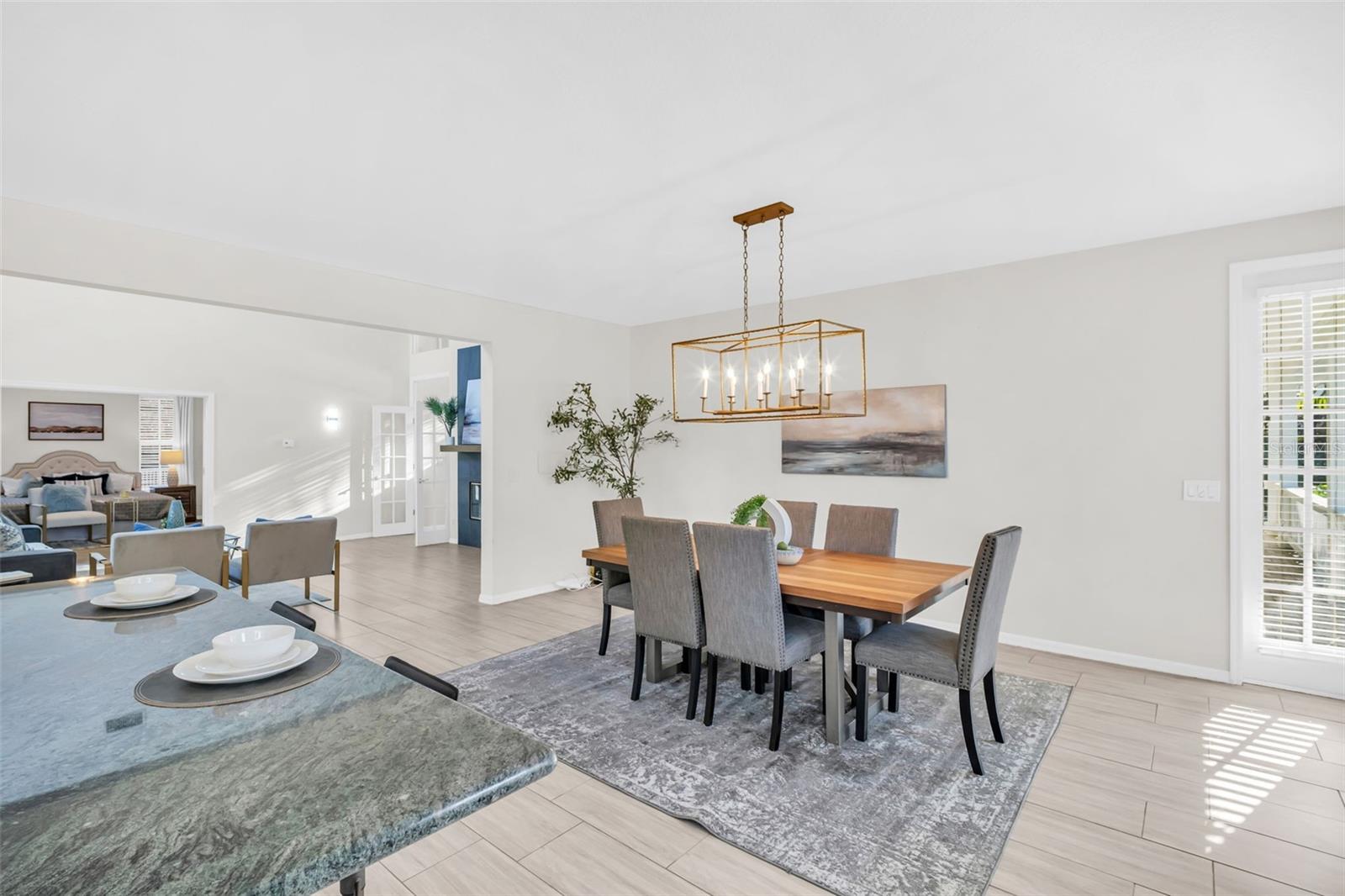 Dining room offers access to the wrap around porch & updated fixtures~