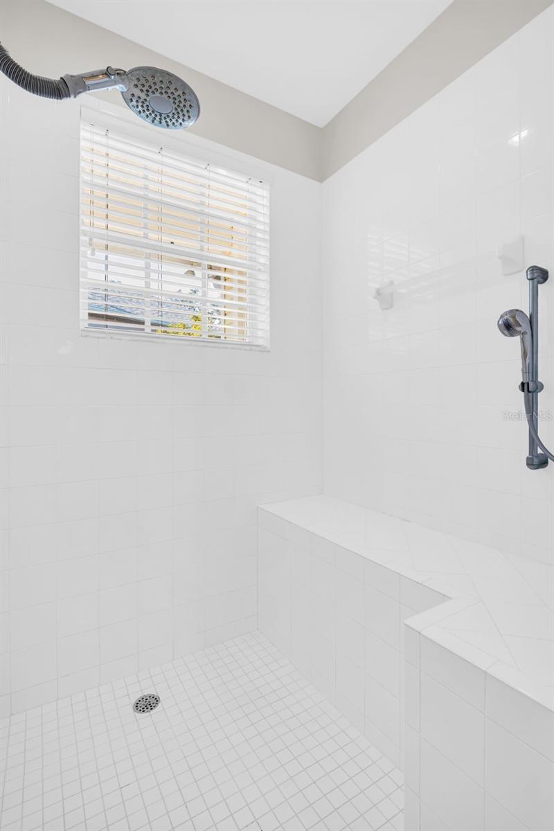 Large walk-in shower with built-in bench~