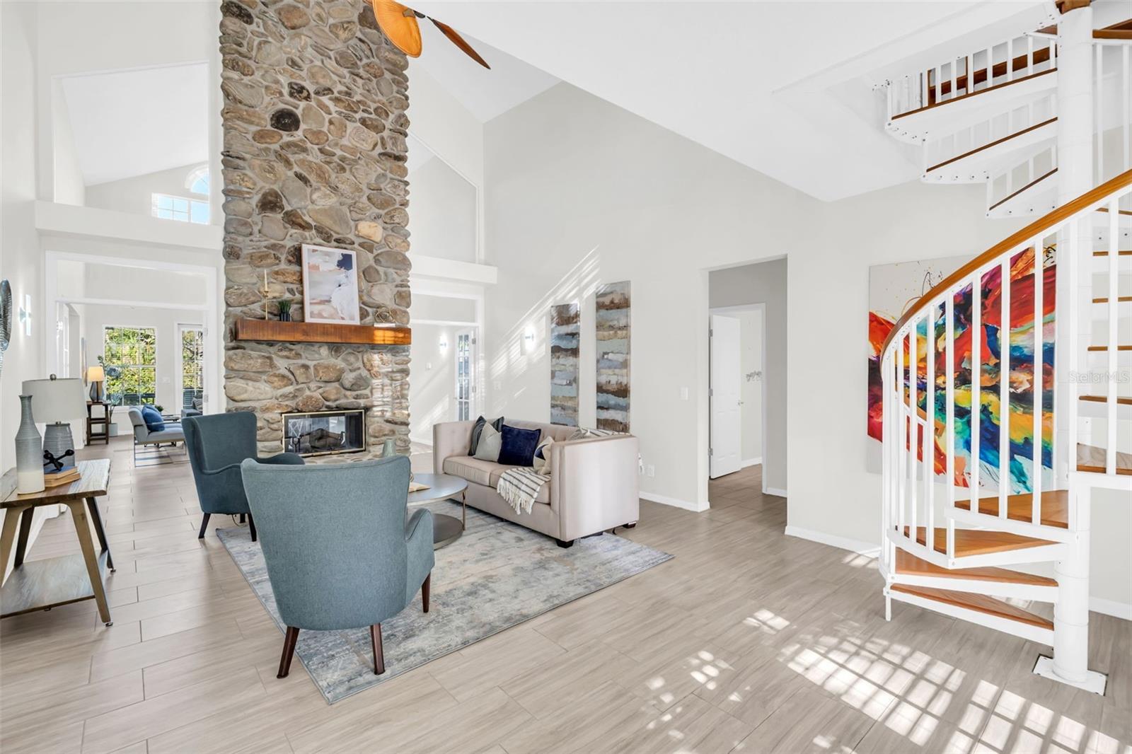 Jaw dropping cathedral ceilings upon entry & beautiful double-sided wood burning fireplace~