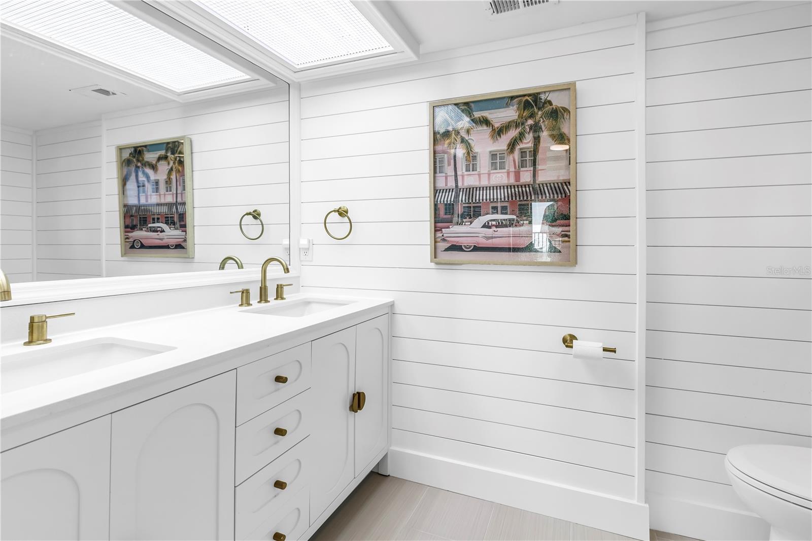 Updated bathrooms with dual vanities.