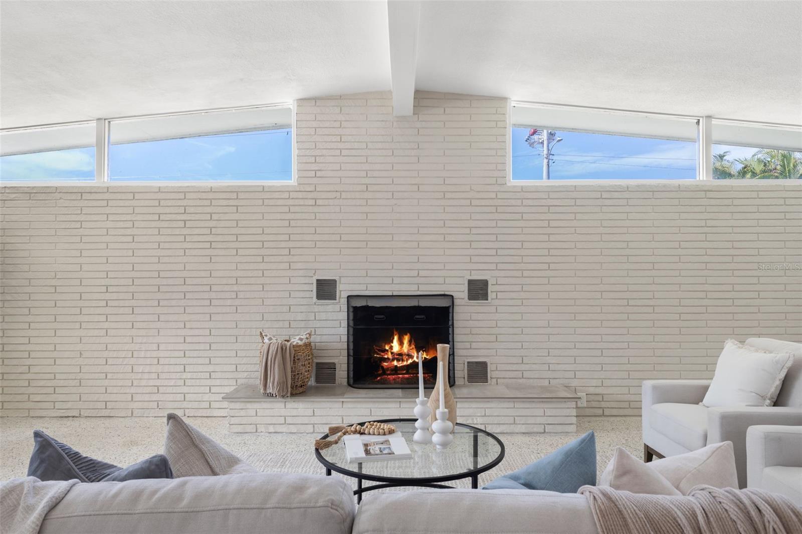 Wood burning hearth daytime view with mid century window design