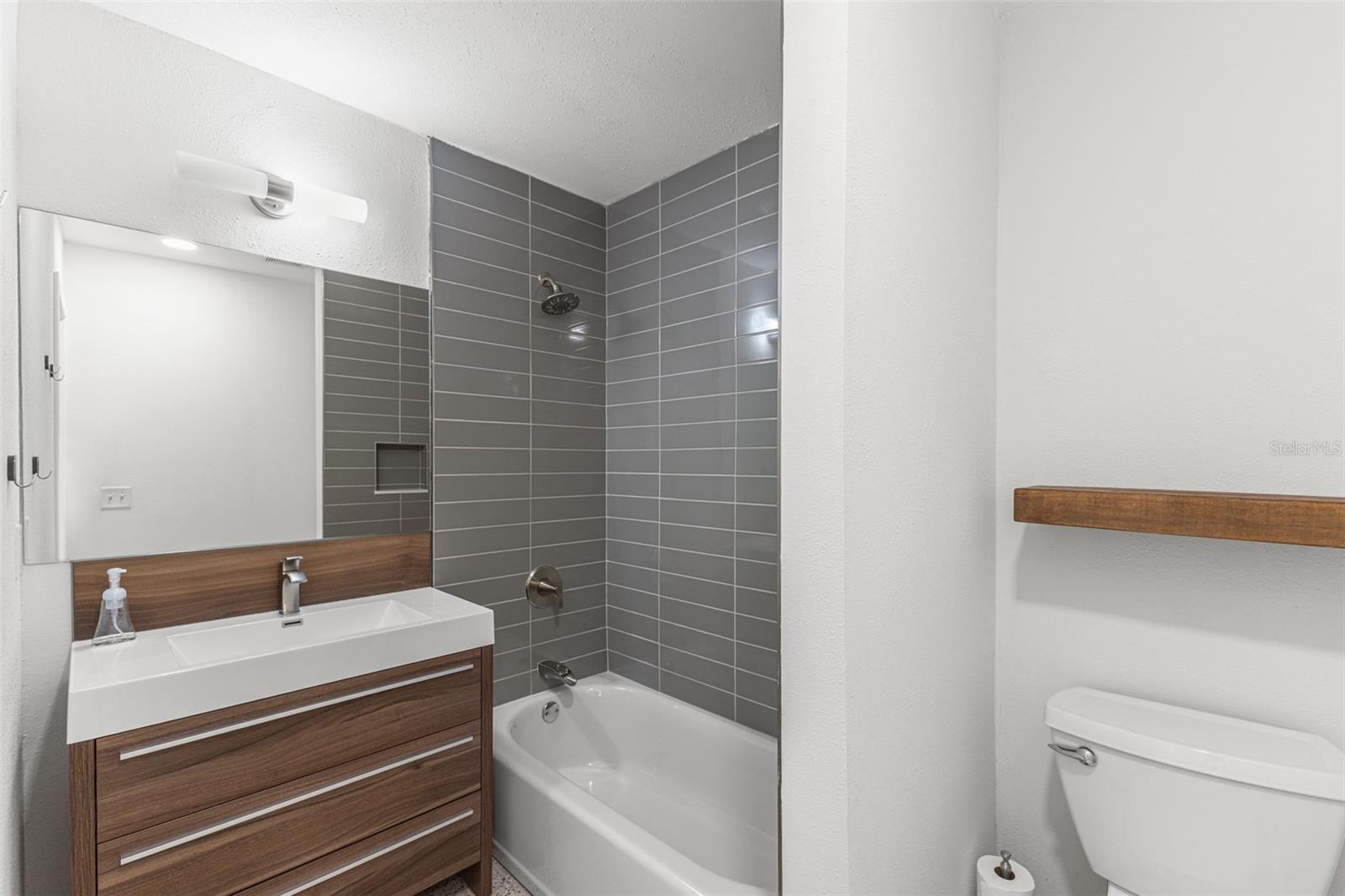 Secondary full bath. Updated with tub-to-ceiling tile.