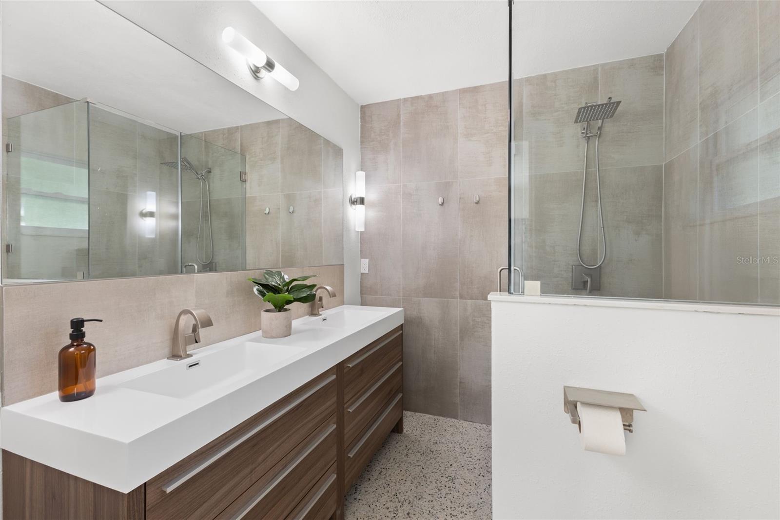Primary bathroom with modern vanity and stand up shower