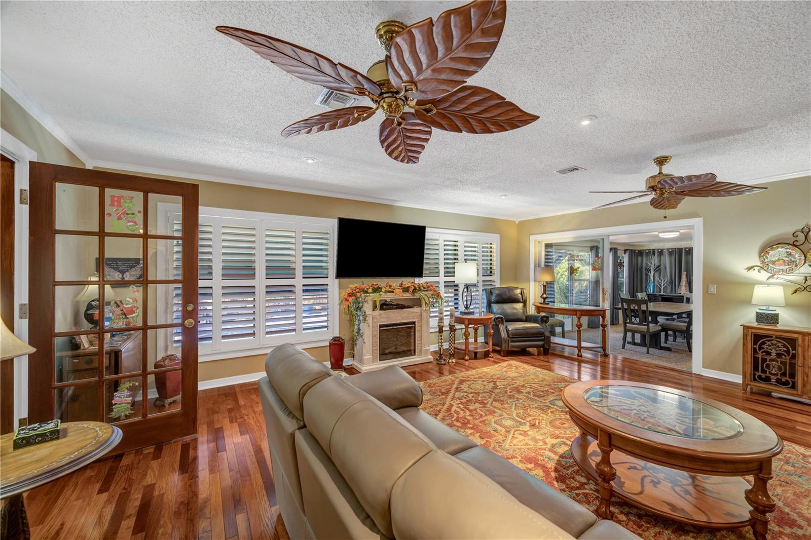 Living Room door to left leads to Den/Office and view of enclosed Florida Room to the right