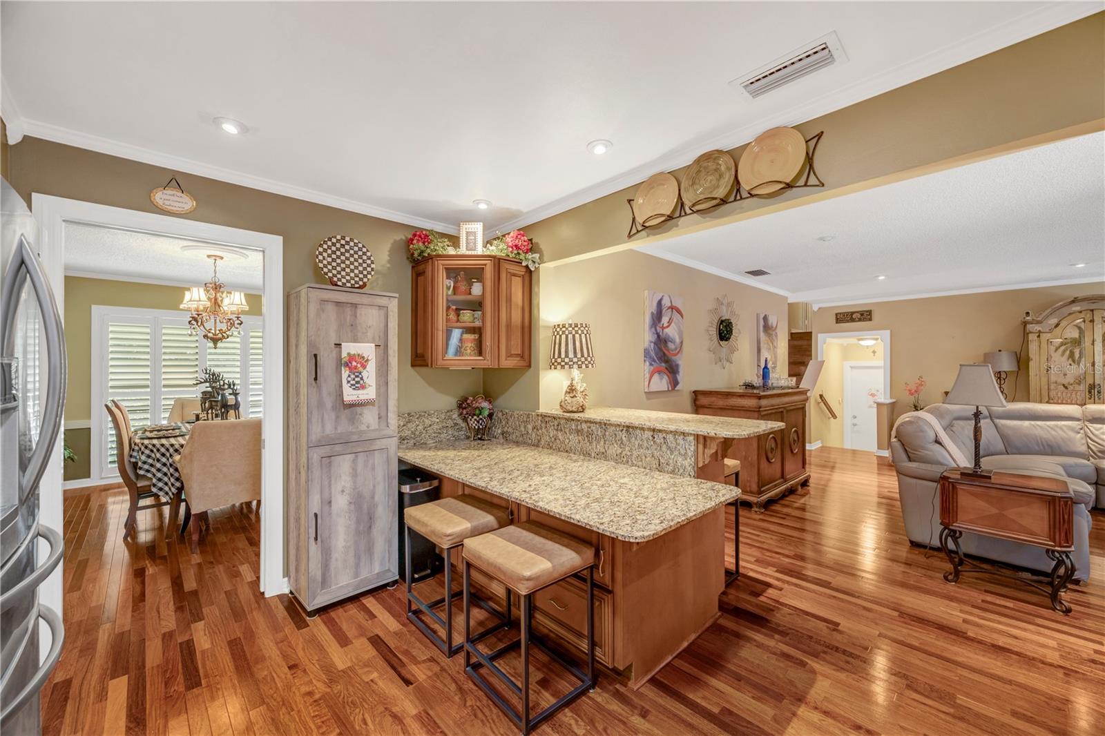 Kitchen with view into Formal Dining Room to left and Family Room to right