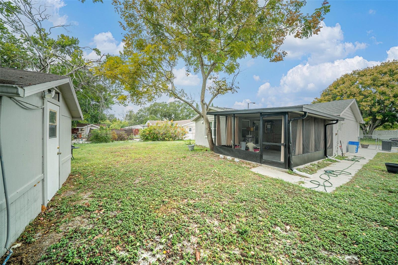 Back yard with view of shed and house