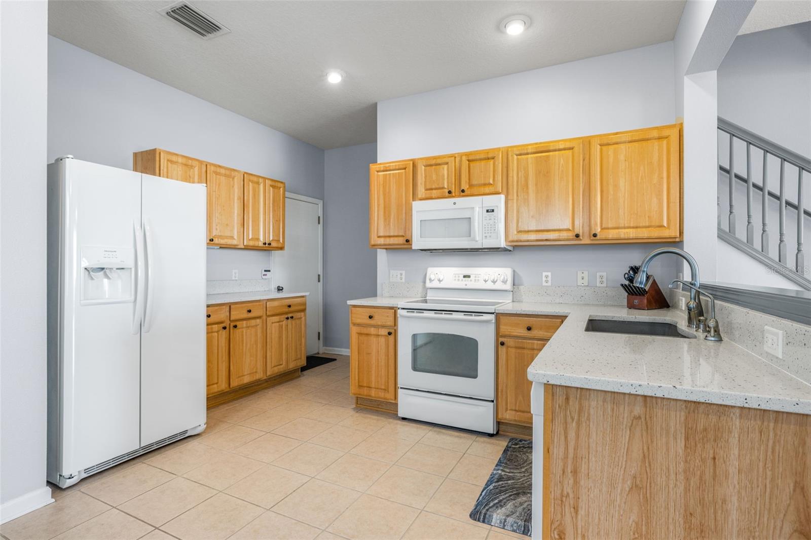 Kitchen has large walk in Closet across from Garage Entry Door, Quartz Counters very tastefully installed!