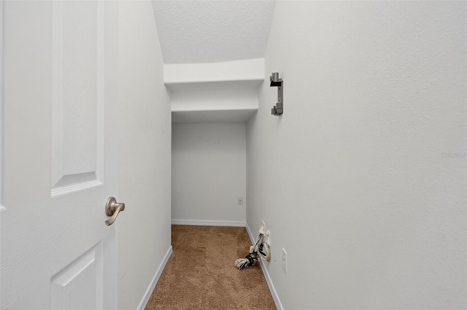 HUGE under the stairs storage area! Continues all the way to the back left