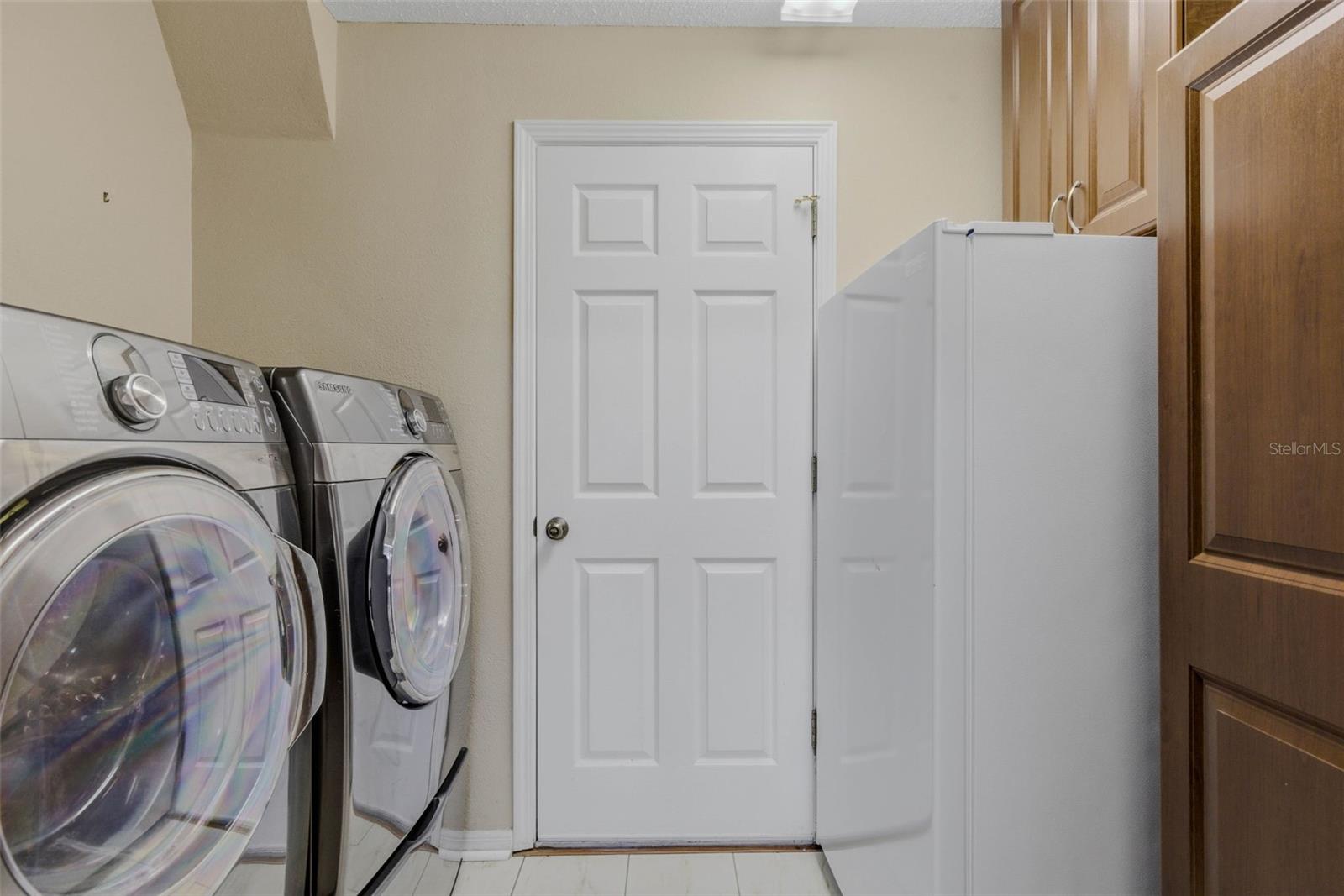 Utility Area between the kitchen and 2 car garage with more storage