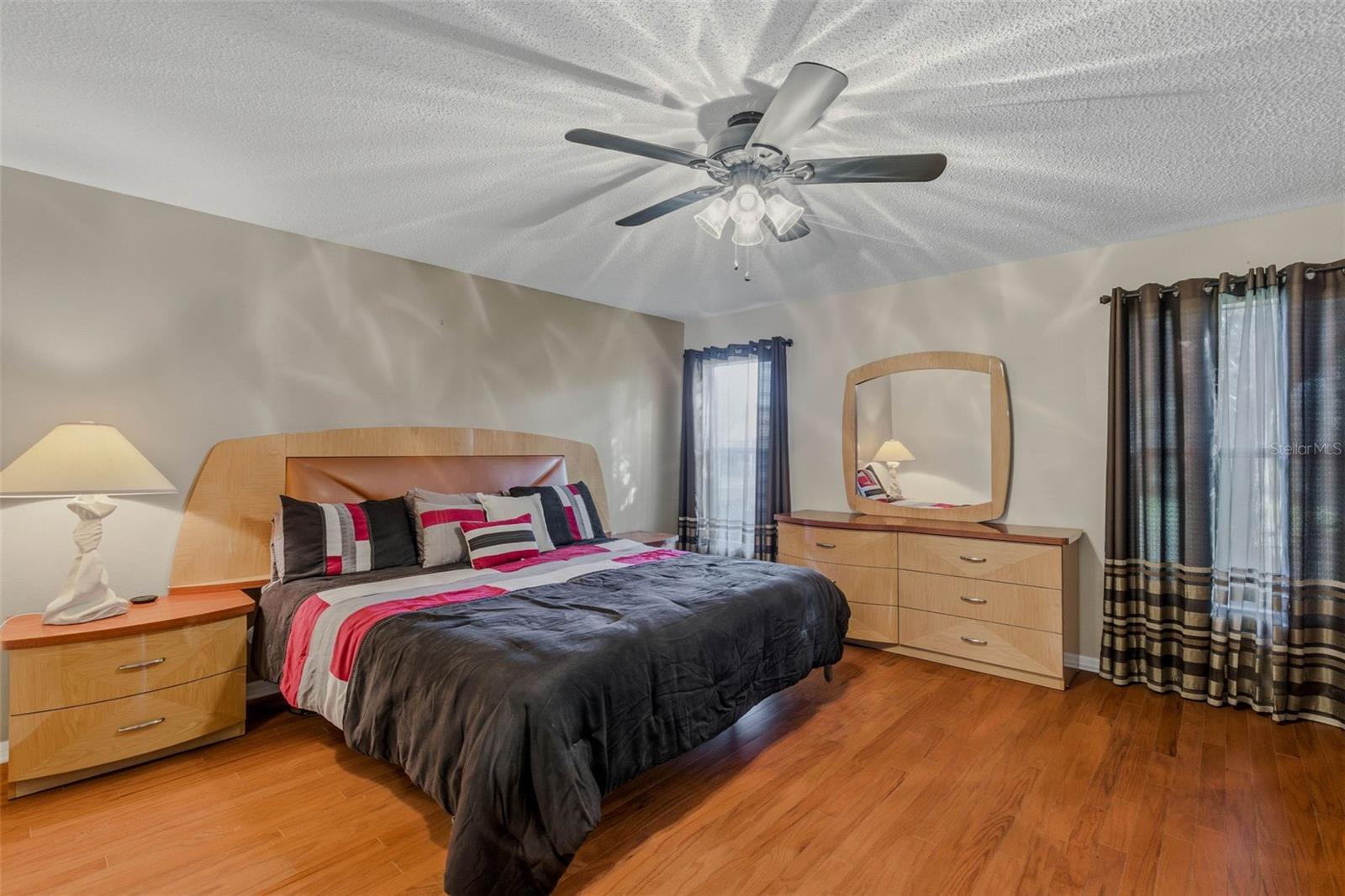 Primary suite continues the elegant hardwood floors, creating seamless flow throughout the home.