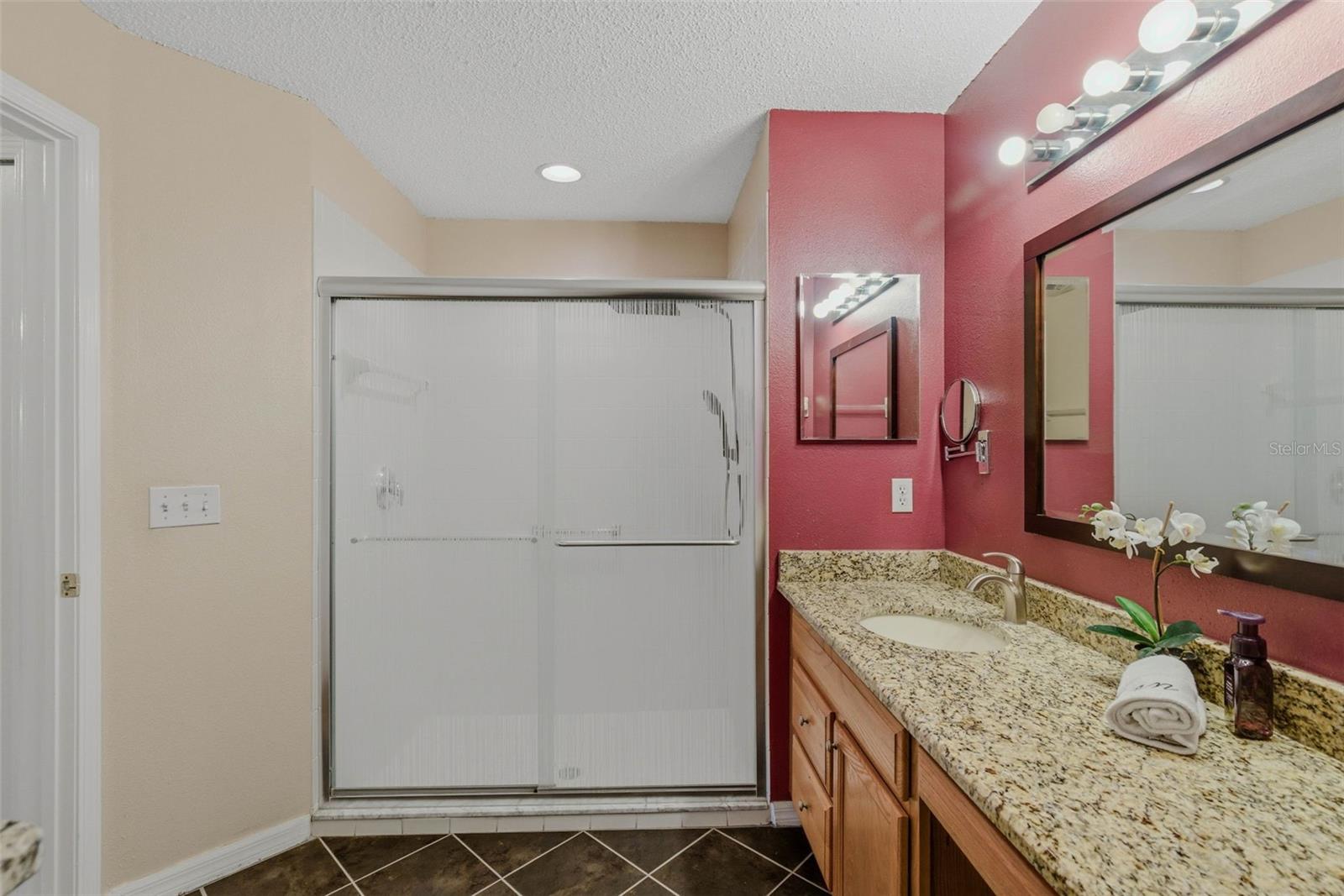 Another angle of the tiled bathroom, emphasizing its clean and modern look.
