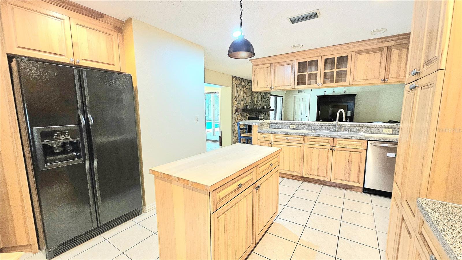 A nice size kitchen with an island to save steps.