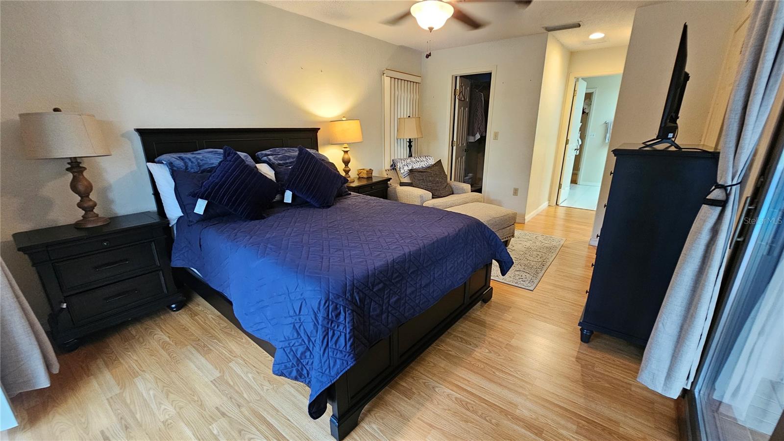 Main bedroom has a beautiful pool and green space view.