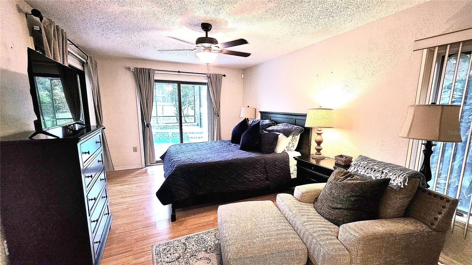 Main bedroom has a beautiful pool and green space view.