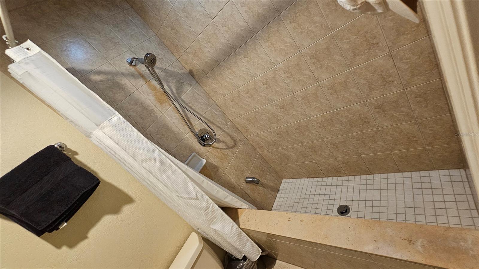A shower with a high wall perfect for your pets.