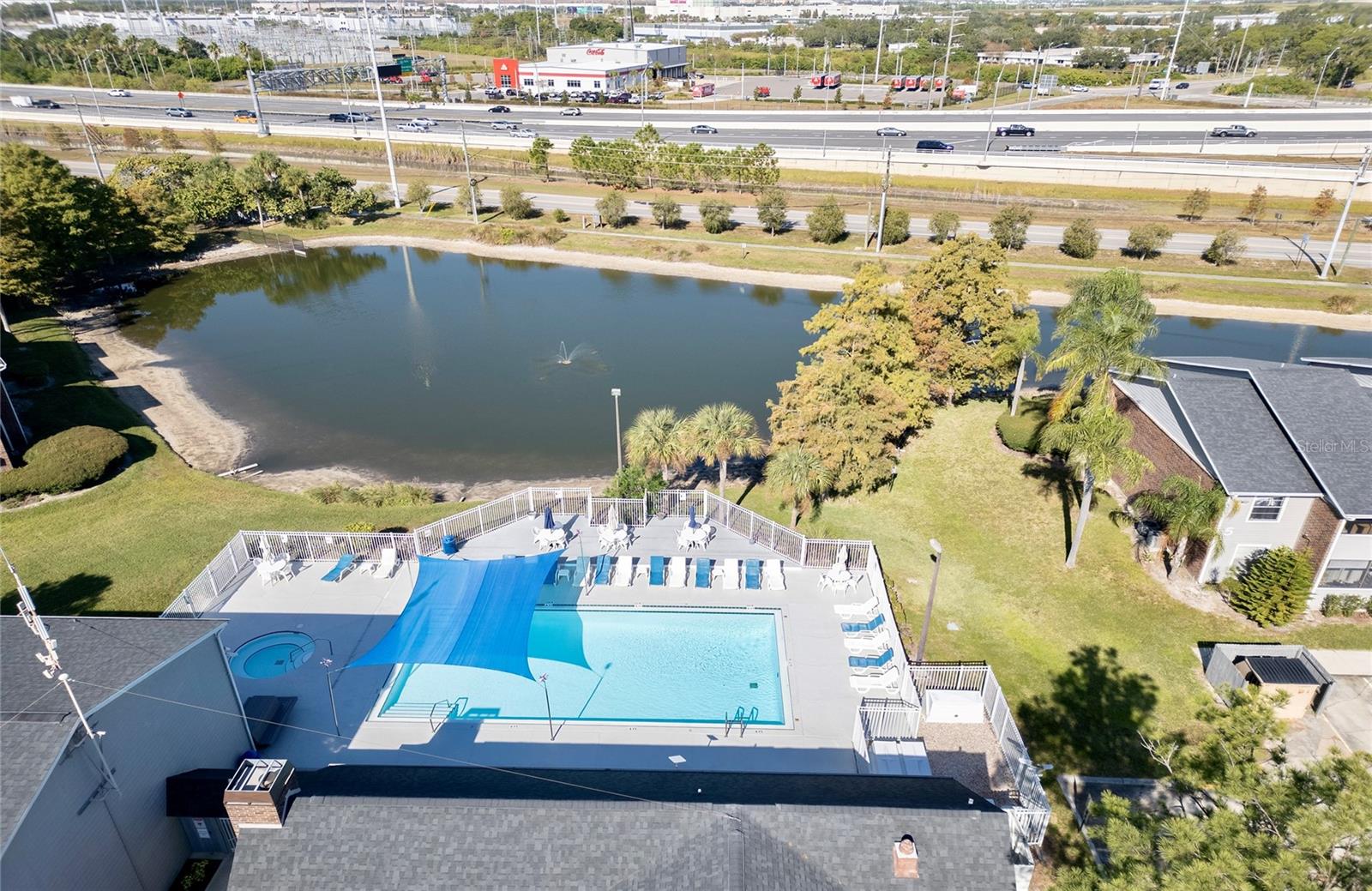 Community pool and clubhouse next to the pond
