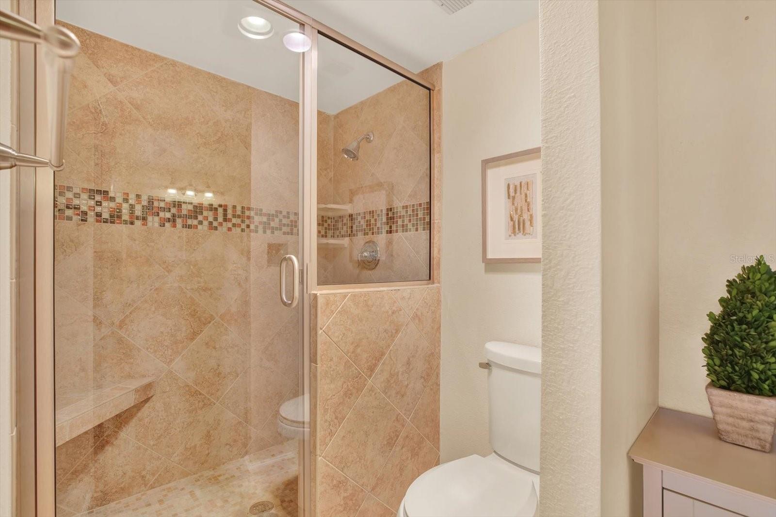 Primary bathroom with a walk-in shower.