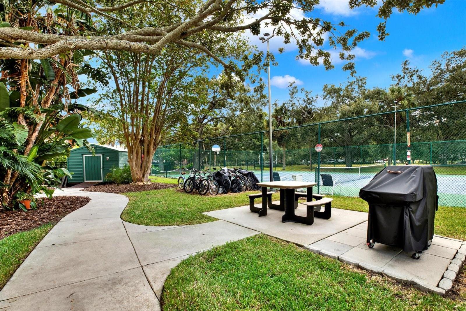 Grill, bike rack, and picnic table.